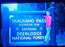 Boy at skalkaho pass sign